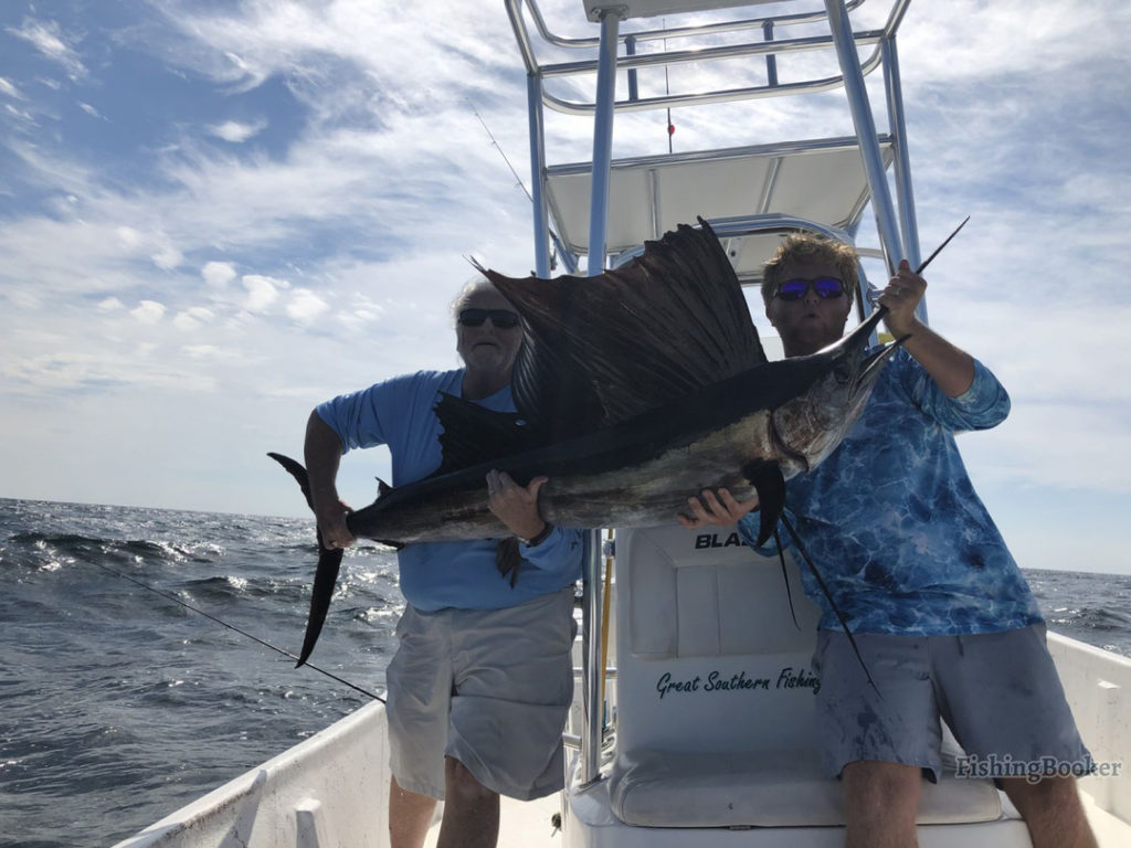 father and son holding a large Sailfish on Great Southern Fishing Charters out of Orange Beach, AL