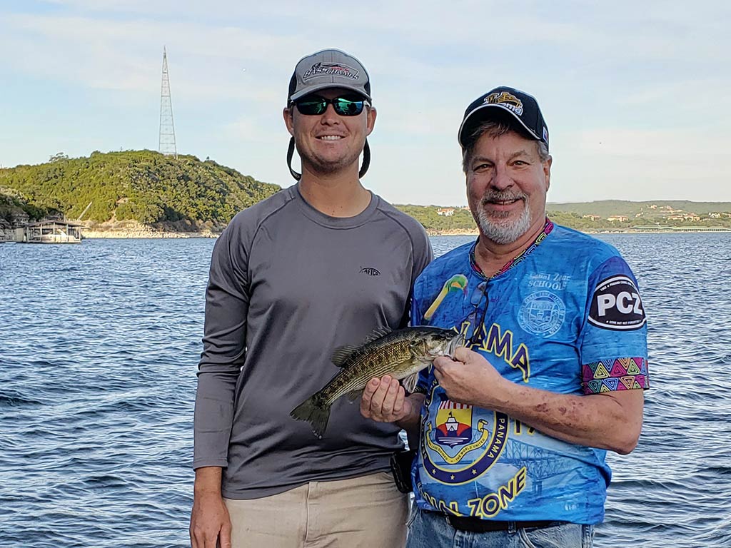 Two anglers with a Guadalupe Bass, the state fish of Texas