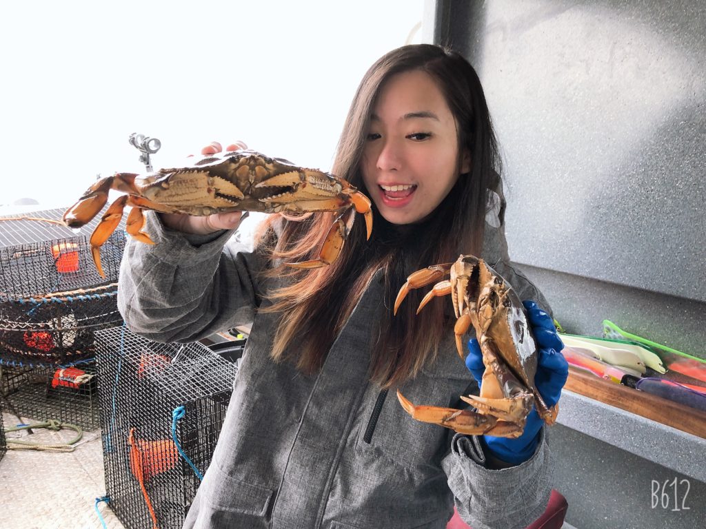 Angler holding two Crabs caught with Amazing Fishing Charters in BC, Canada