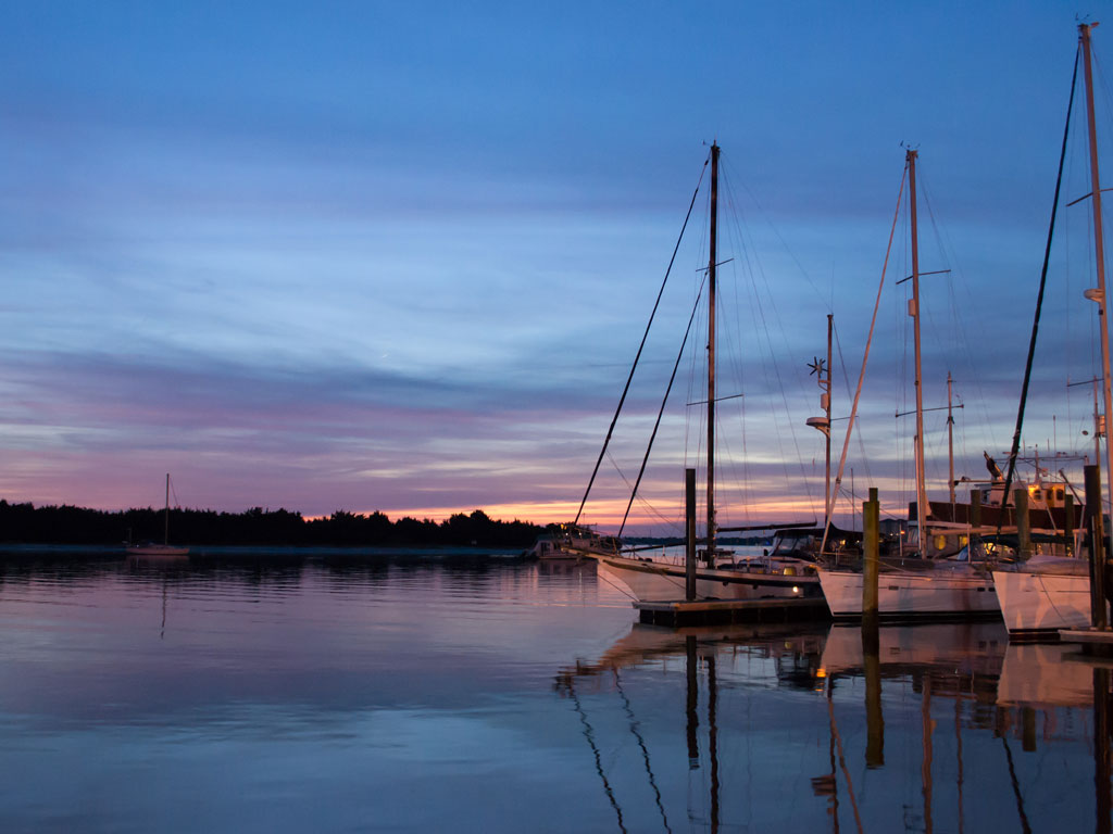 A photo of docked sailboats at sunset in Beaufort, North Carolina.