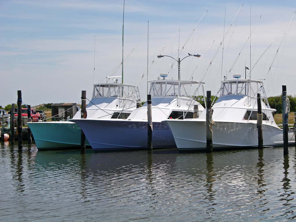 A photo of three docked charter fishing boats.
