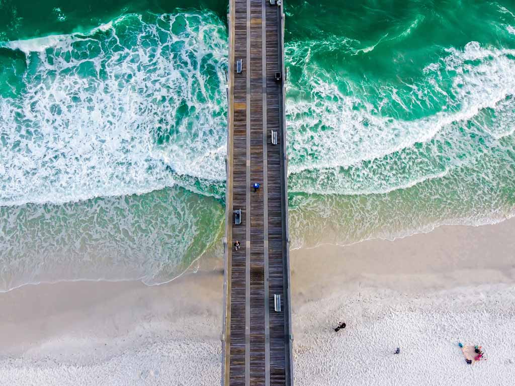 A birds-eye view of Pensacola Pier and the surrounding beach.