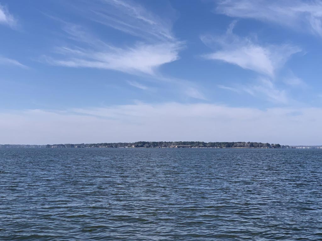 A photo of Lake Conroe's waters with the lake's shores visible in the distance.