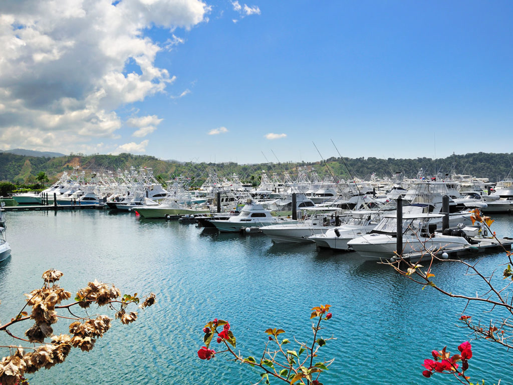 Sportfishing boats pack the marina in Los Sueños, Costa Rica, with mountains in the background