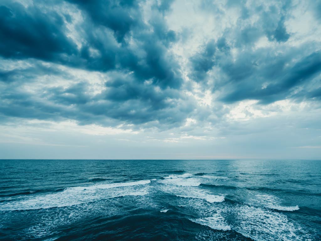 A photo showing clouds above ocean water.