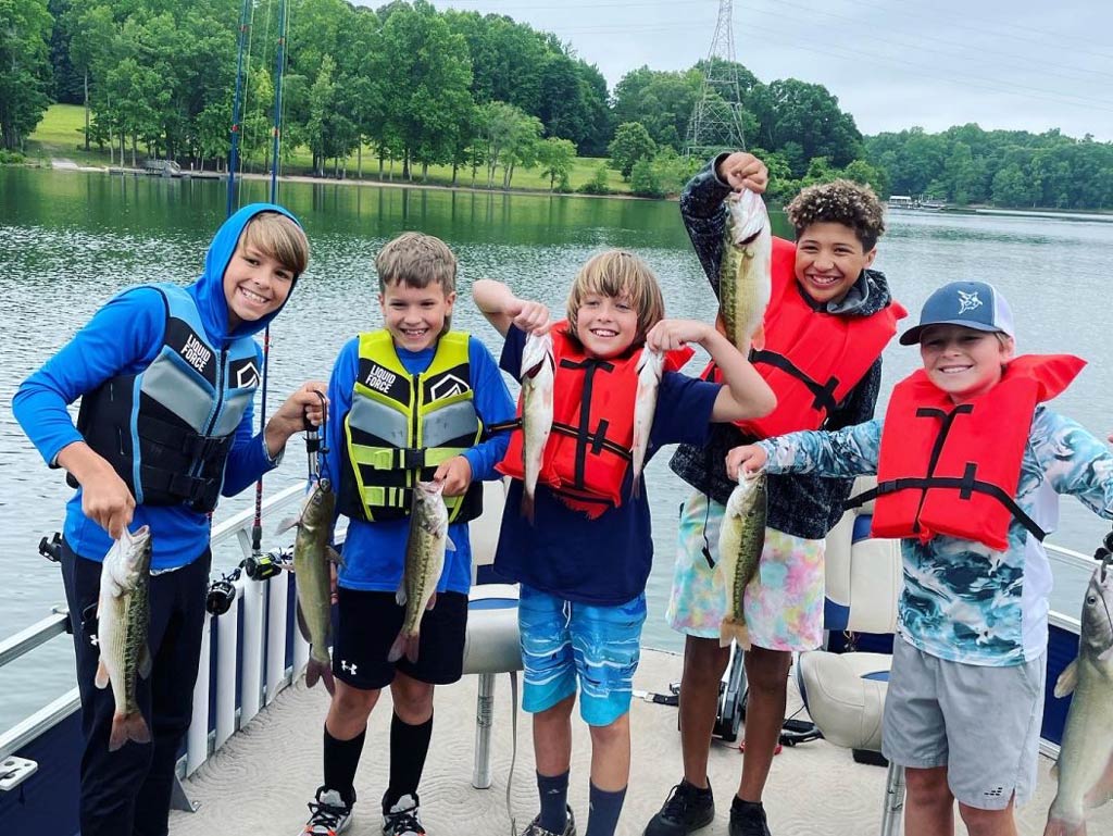 A group of happy kids holding their their catch on Lake Norman