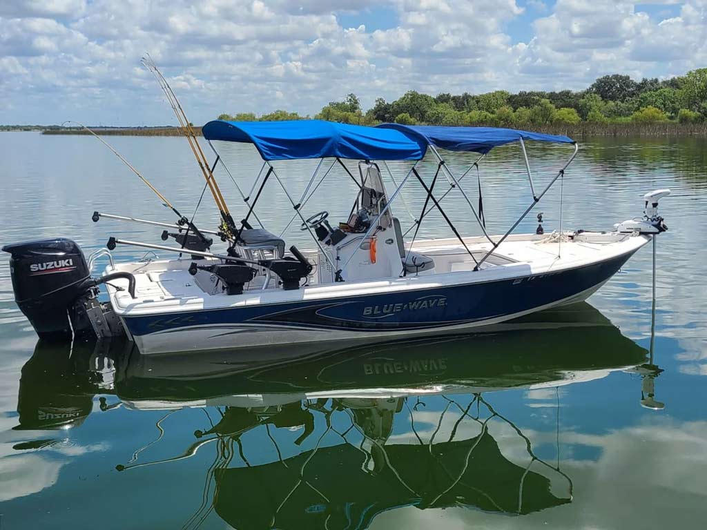 A photo of one of the fishing guide boats and calm waters on Calaveras Lake.
