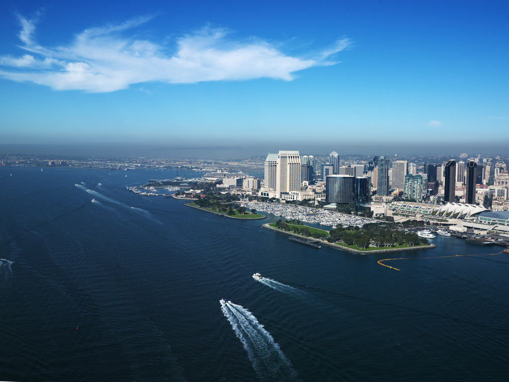 An aerial shot of San Diego, one of the best fishing cities in the US, and its coasts, with boats riding through the water.