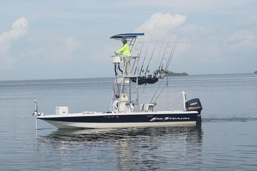 A center console fishing boat on the waters of Longboat Key, with captain on board