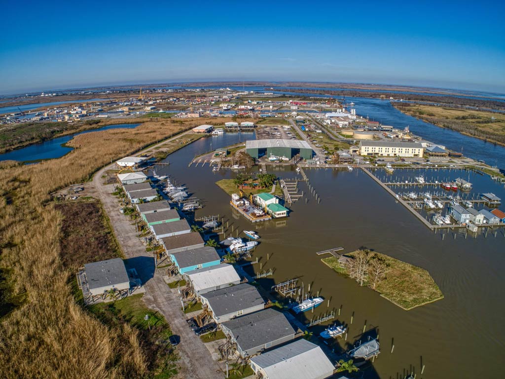 An aerial view of the marina and shoreline buildings in Venice, Louisiana.