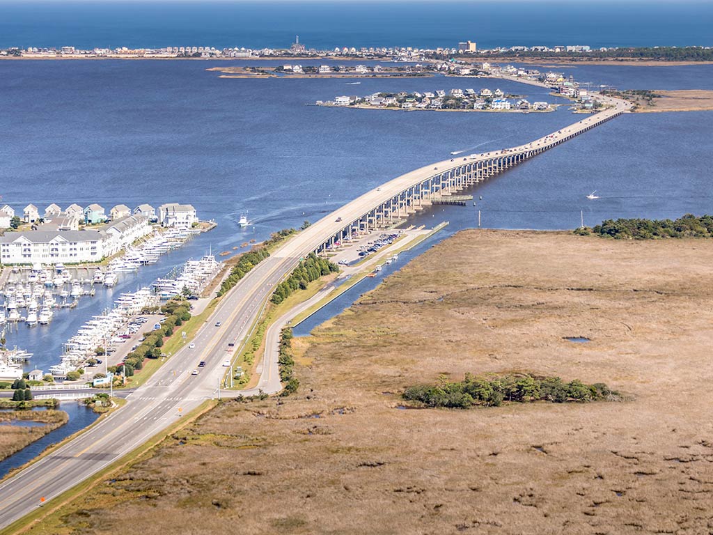 An aerial view looking from Manteo across the sound towards Nag's Head on the Outer Banks on a clear day, with dry land visible on the right of the image