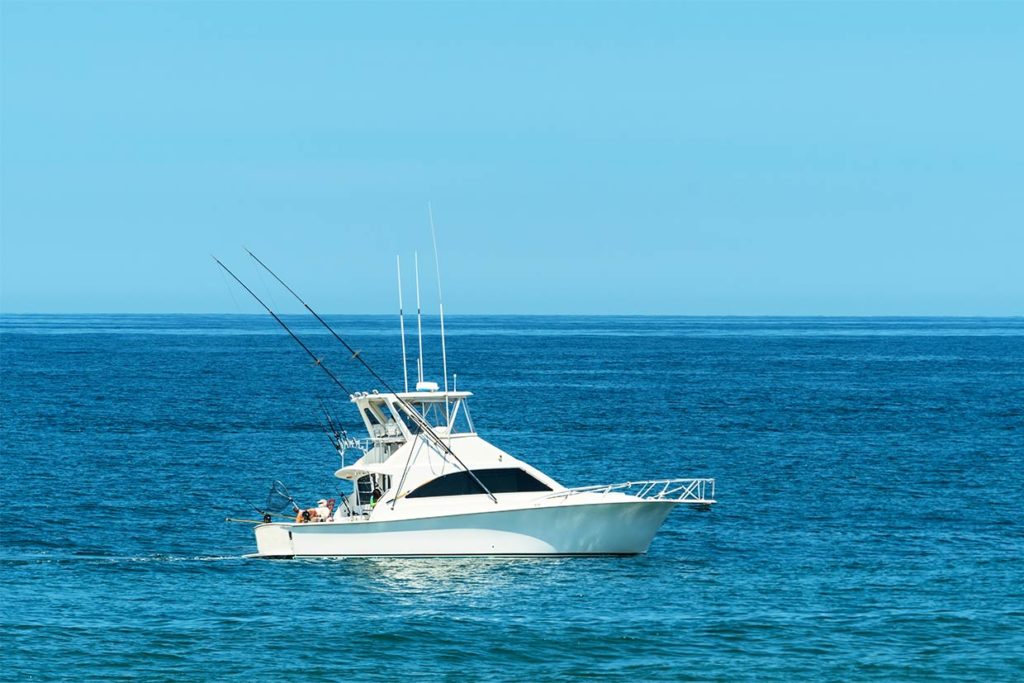 A large sportfishing yacht boat trolls the open waters of the Gulf of Mexico