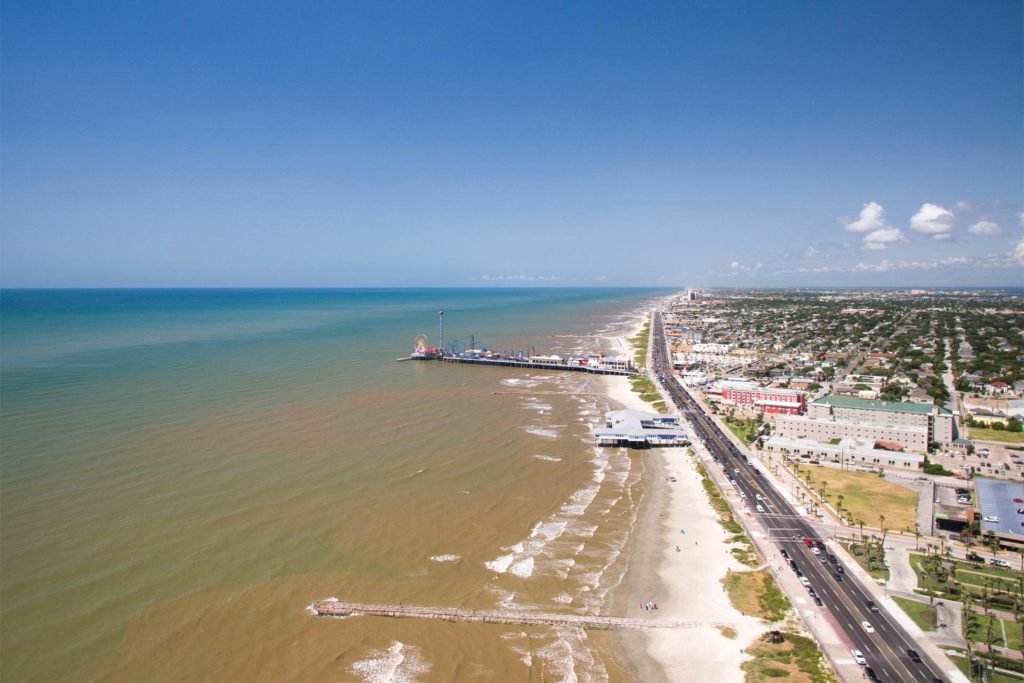 An aerial view of Galveston with the theme park sticking out