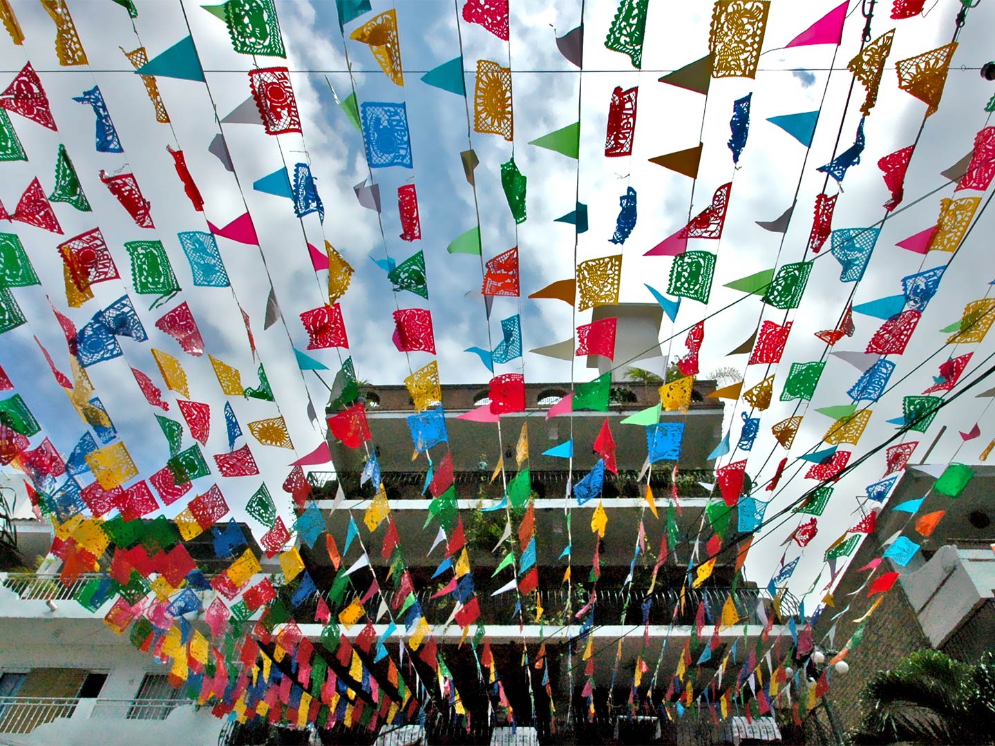 Decorations hanging from a first-floor balcony in preparation for a festival in Puerto Vallarta