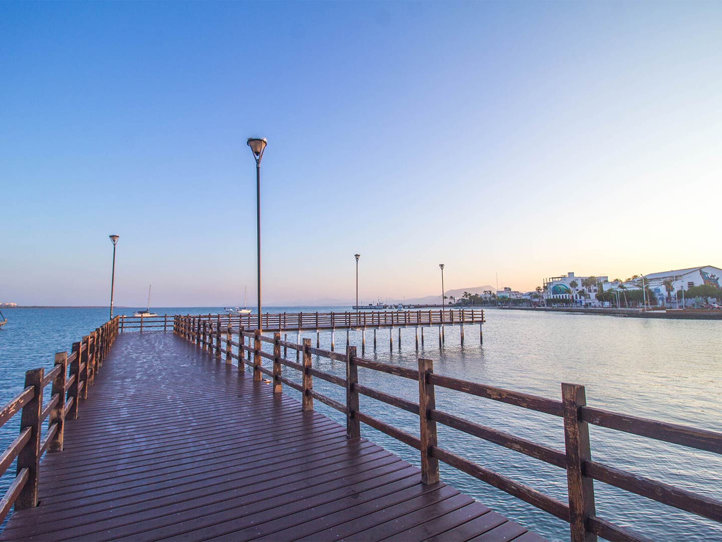 A view from La Paz pier at dusk with a few boats in the background.