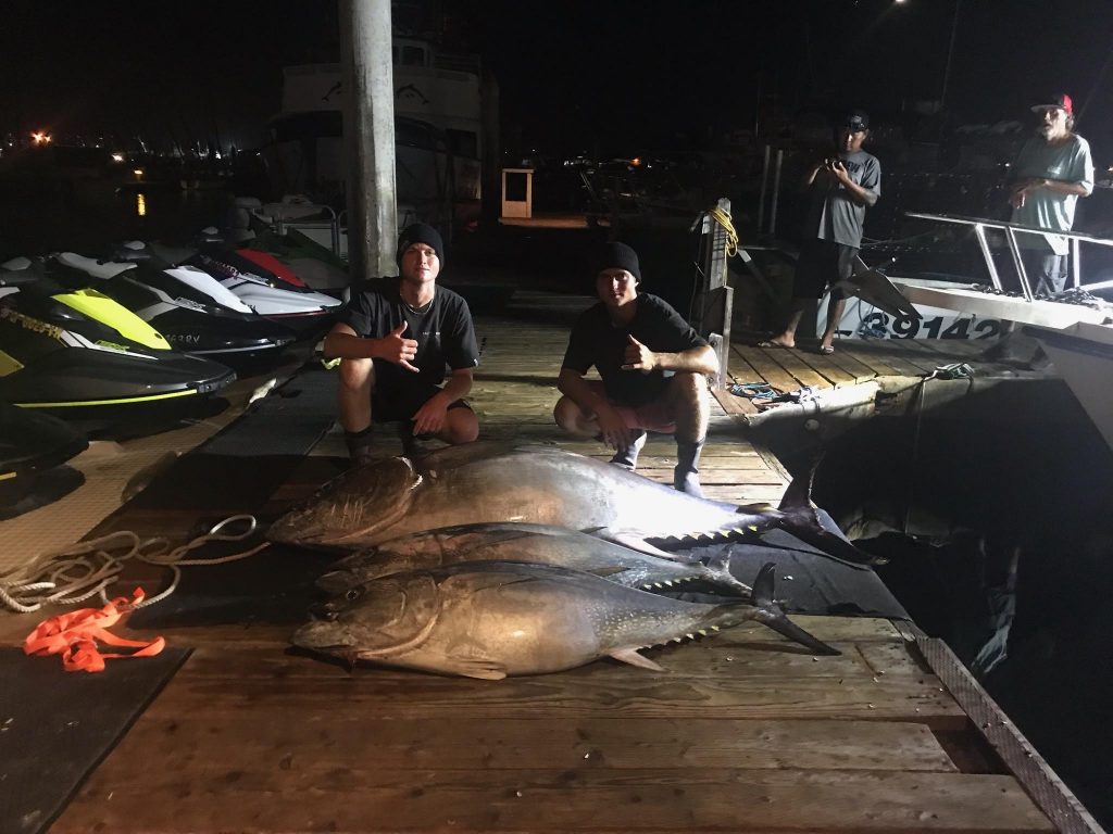 A couple of anglers at the dock posing with large Tunas, San Diego, California