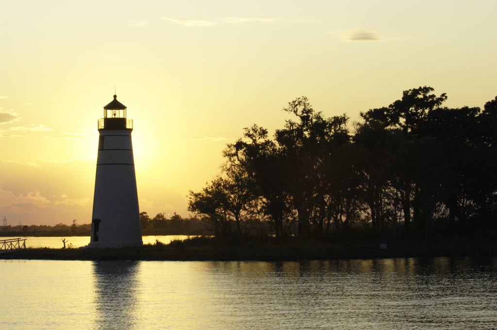 A lighthouse on Lake Pontchartrain at sunset