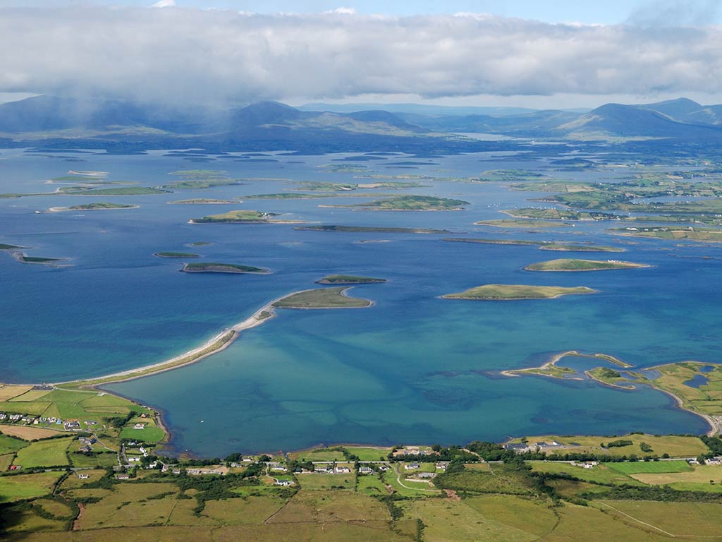 An aerial view looking out into Clew Bay, Co Mayo, with islands visible in the distance on a cloudy day