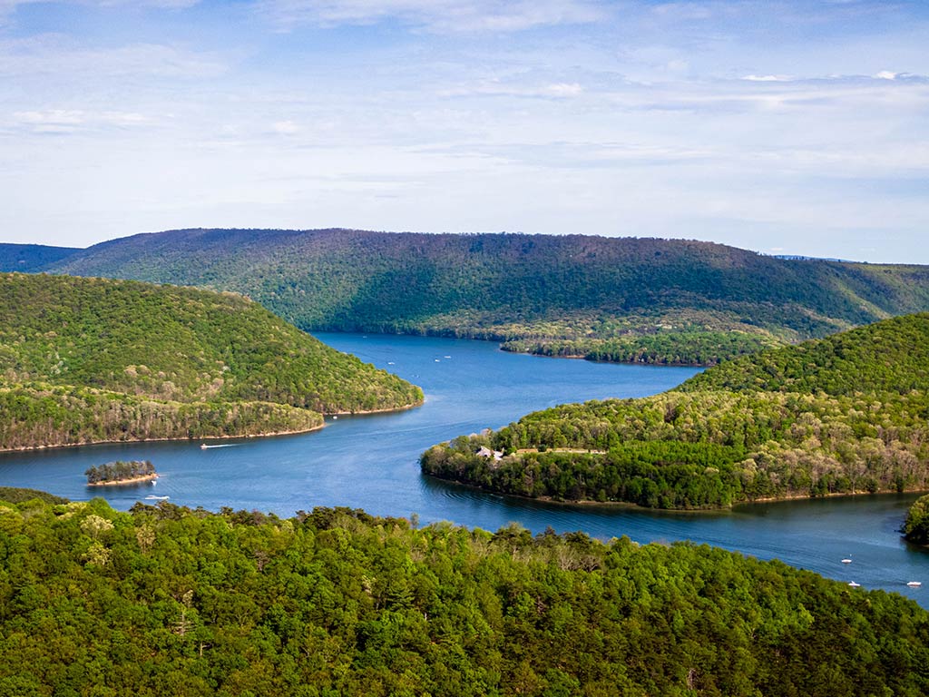 An aerial view looking towards Raystown Lake in Pennsylvania on a clear day as it winds around lush green hills