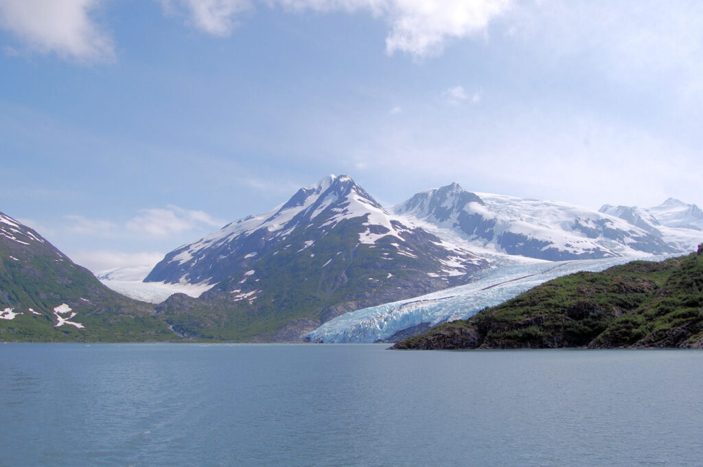 A view across a lake in the Prince William Sound near Whittier, AK, on a cloudy winter's day, looking towards snow-covered hills