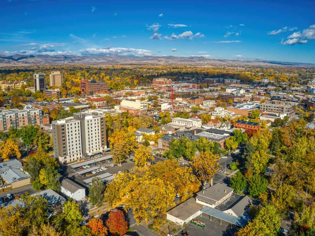 An aerial view of the Fort Collins downtown, with beautiful fall foliage visible between the various city buildings.
