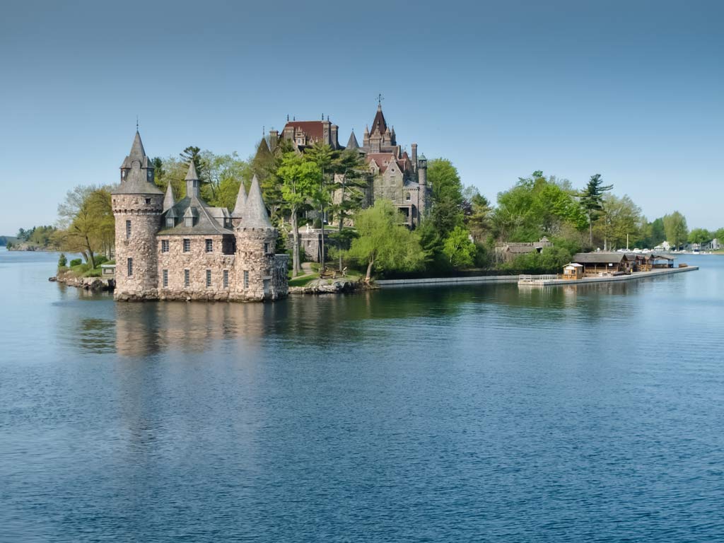 Boldt Castle located in the Thousand Islands,  surrounded by water with a clear sky overhead.