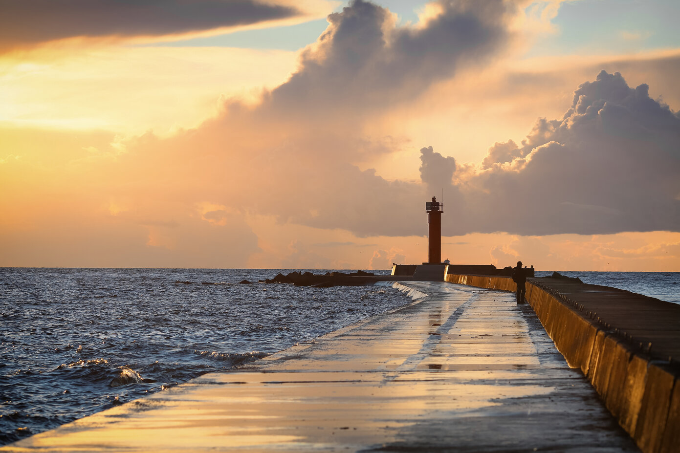 Der Steg zum Leuchtturm in Riga bei Sonnenuntergang.
